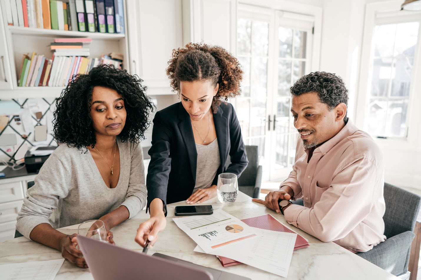 A diverse team reviewing business strategy and performance information together