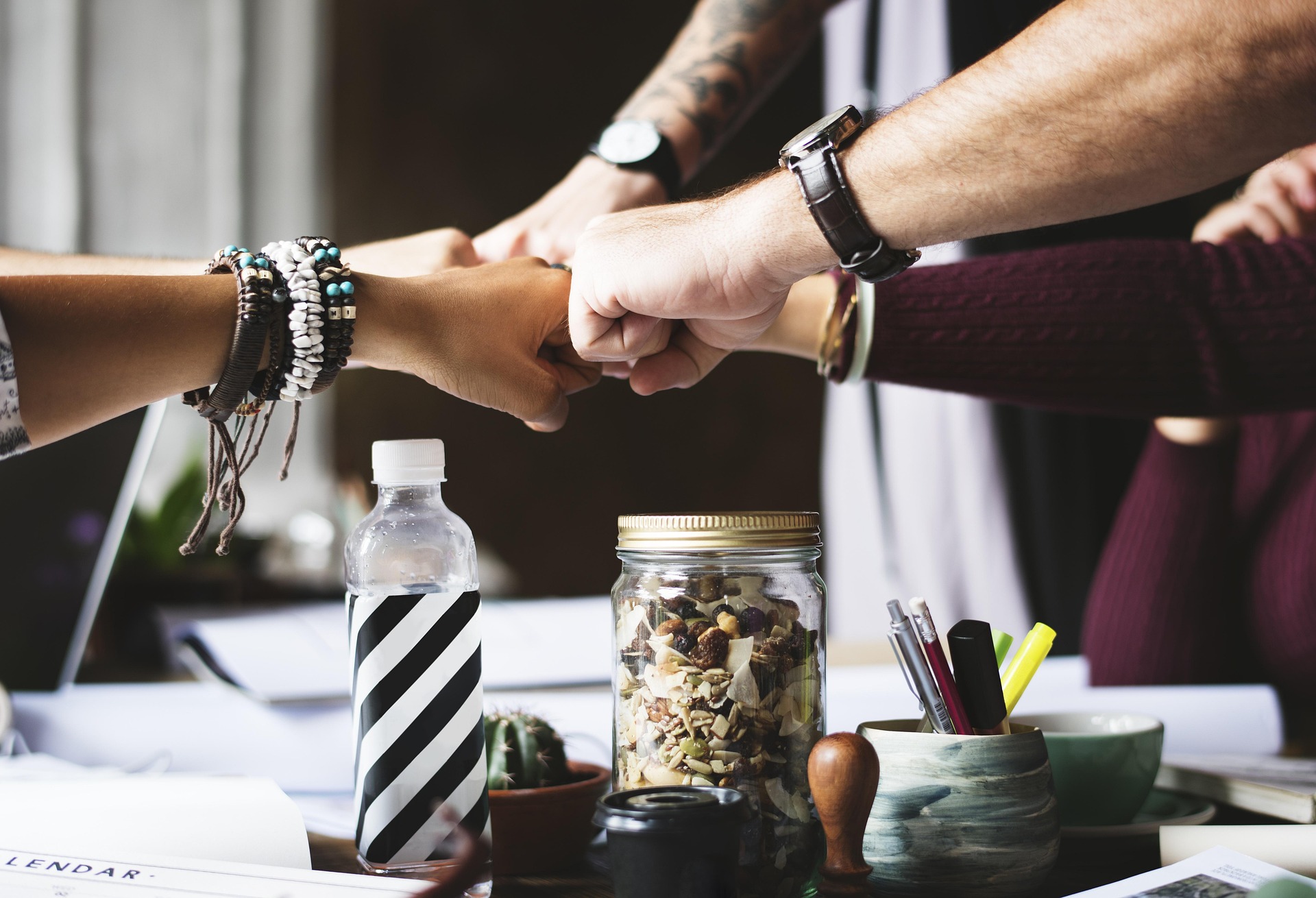 Team members joining their hands in a collaborative gesture